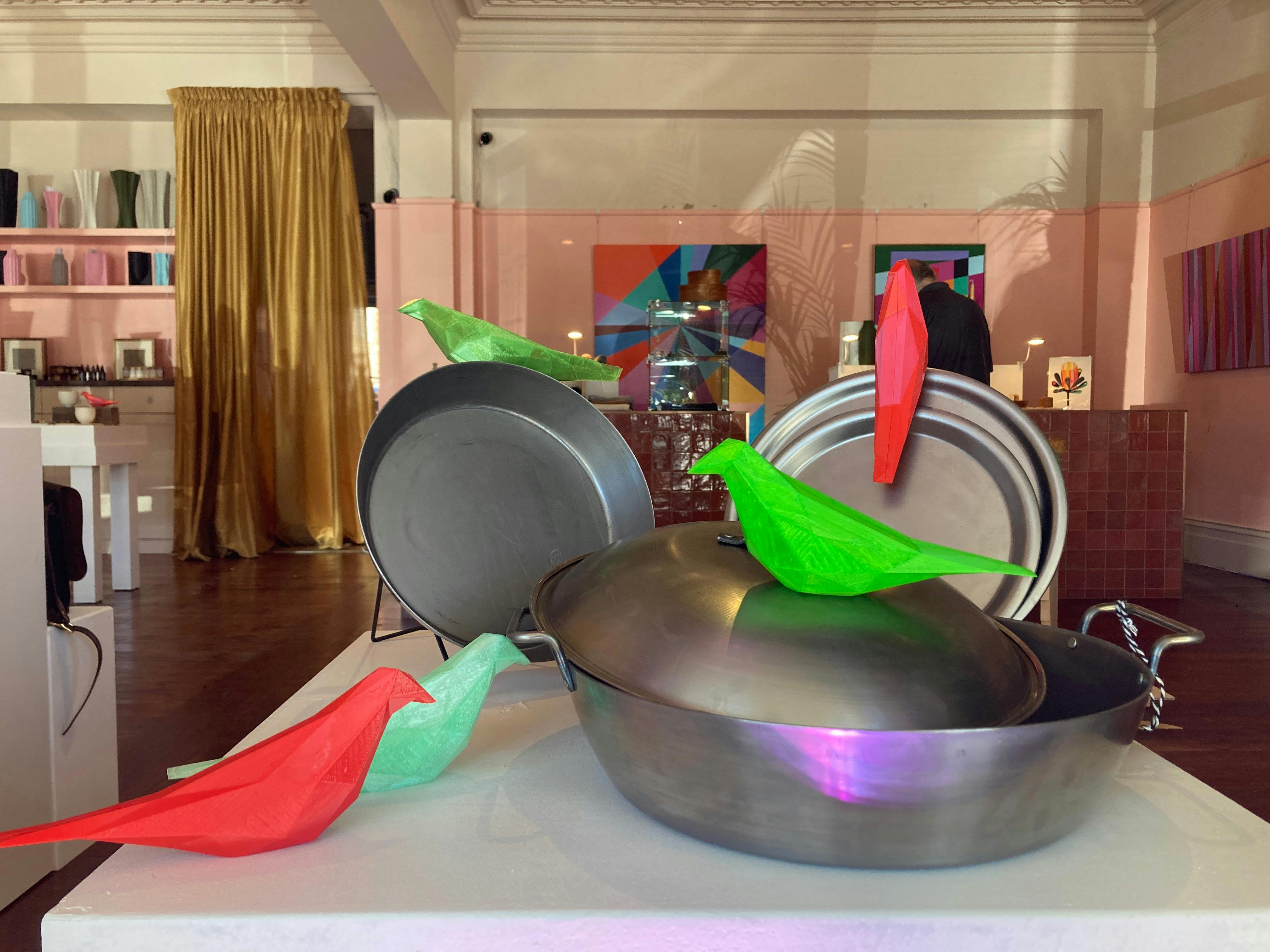 metal cookware and 3D printed birds on display