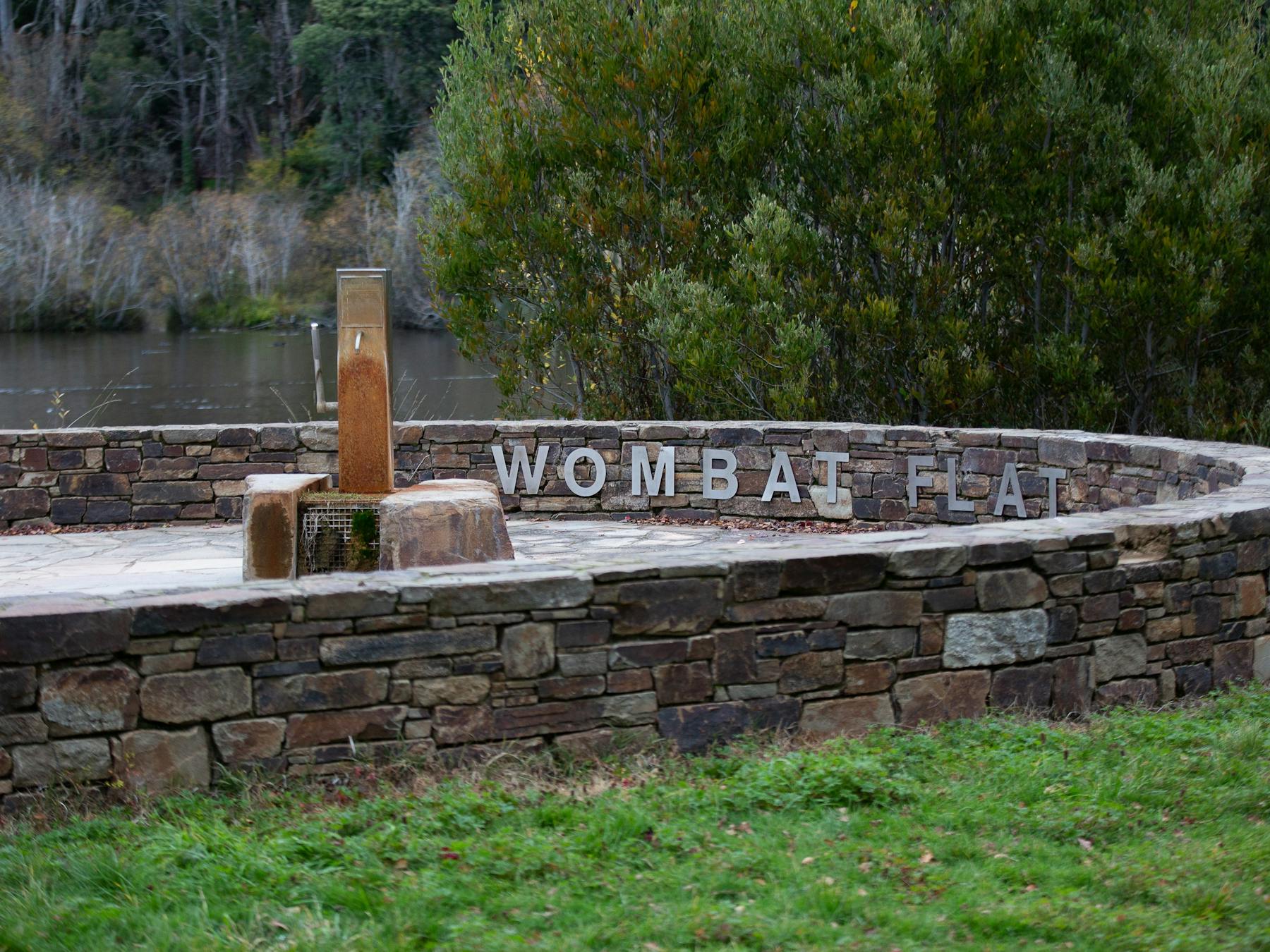 A mineral spring pump next to stonework