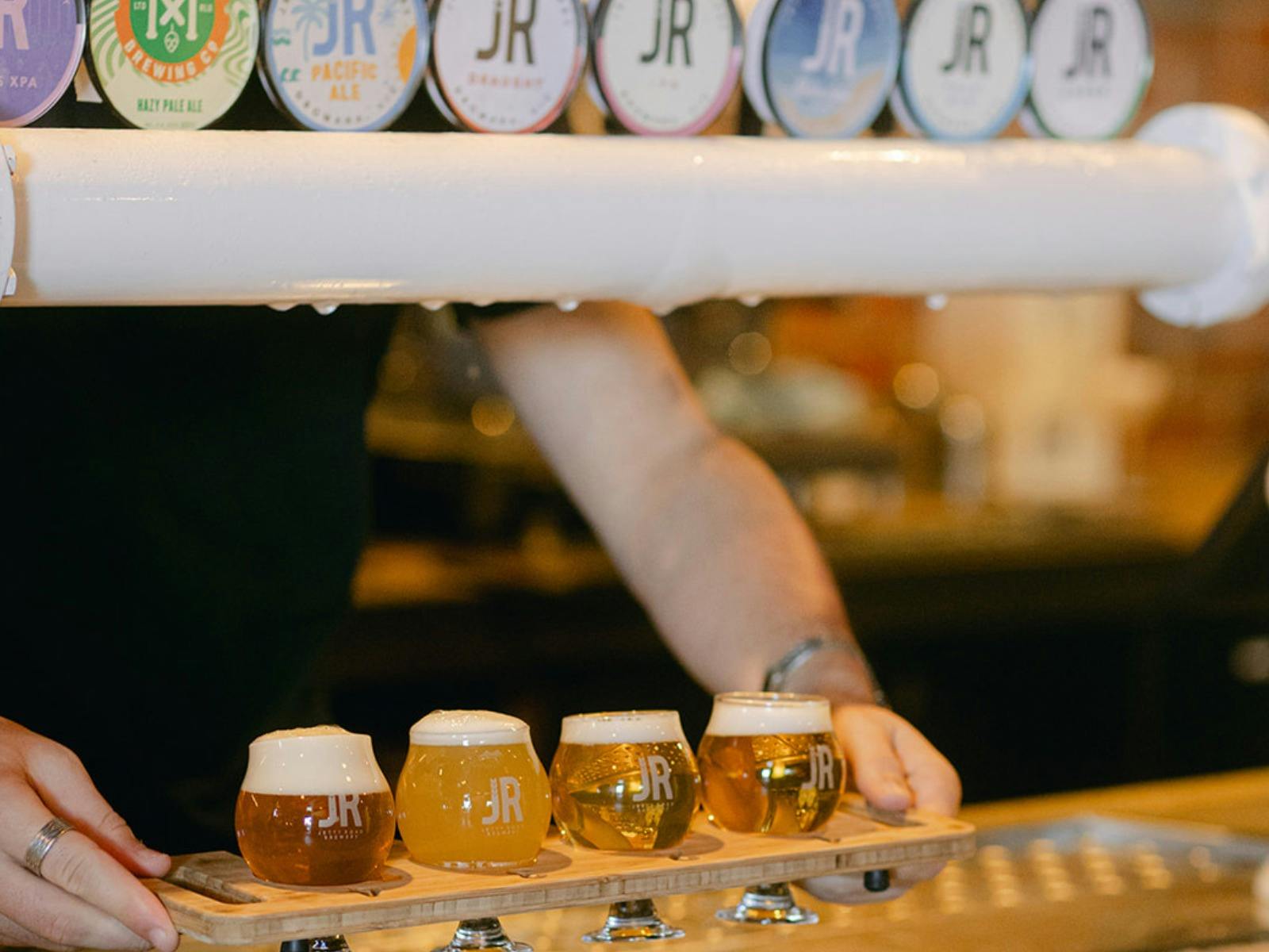 Beer taps and a tasting paddle