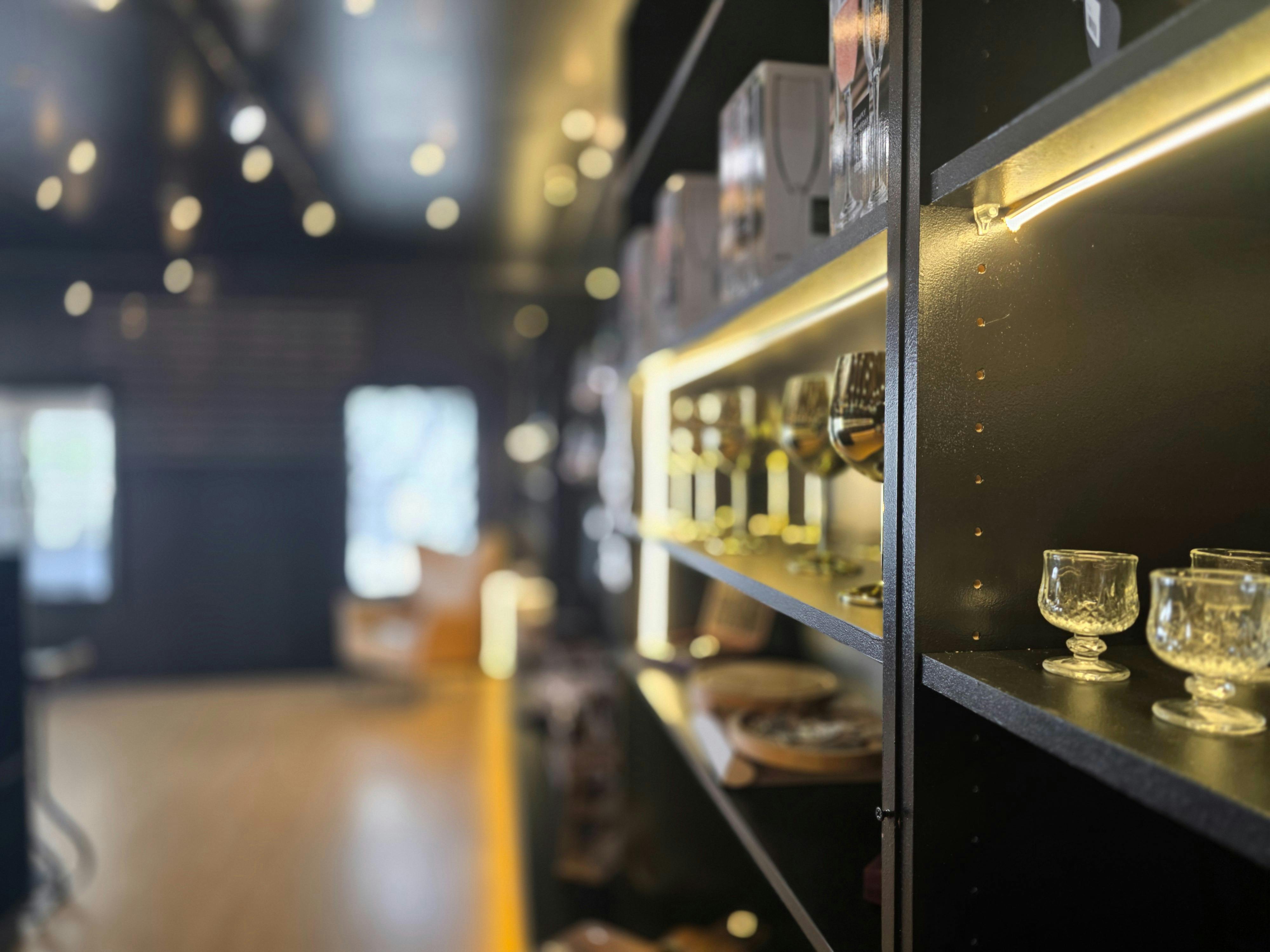 Wall display of wine tools and bar accessories inside the shop.
