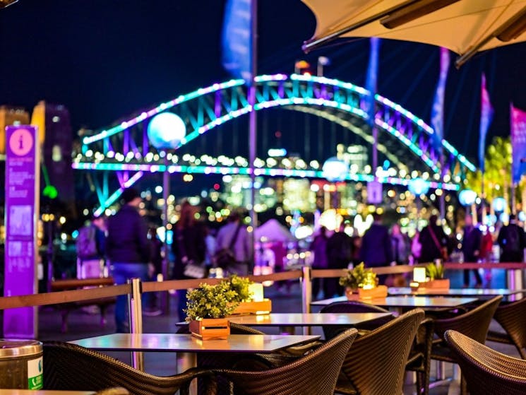 Eastbank Cafe alfresco dining area during VIVID times overlooking the Sydney Harbour Bridge