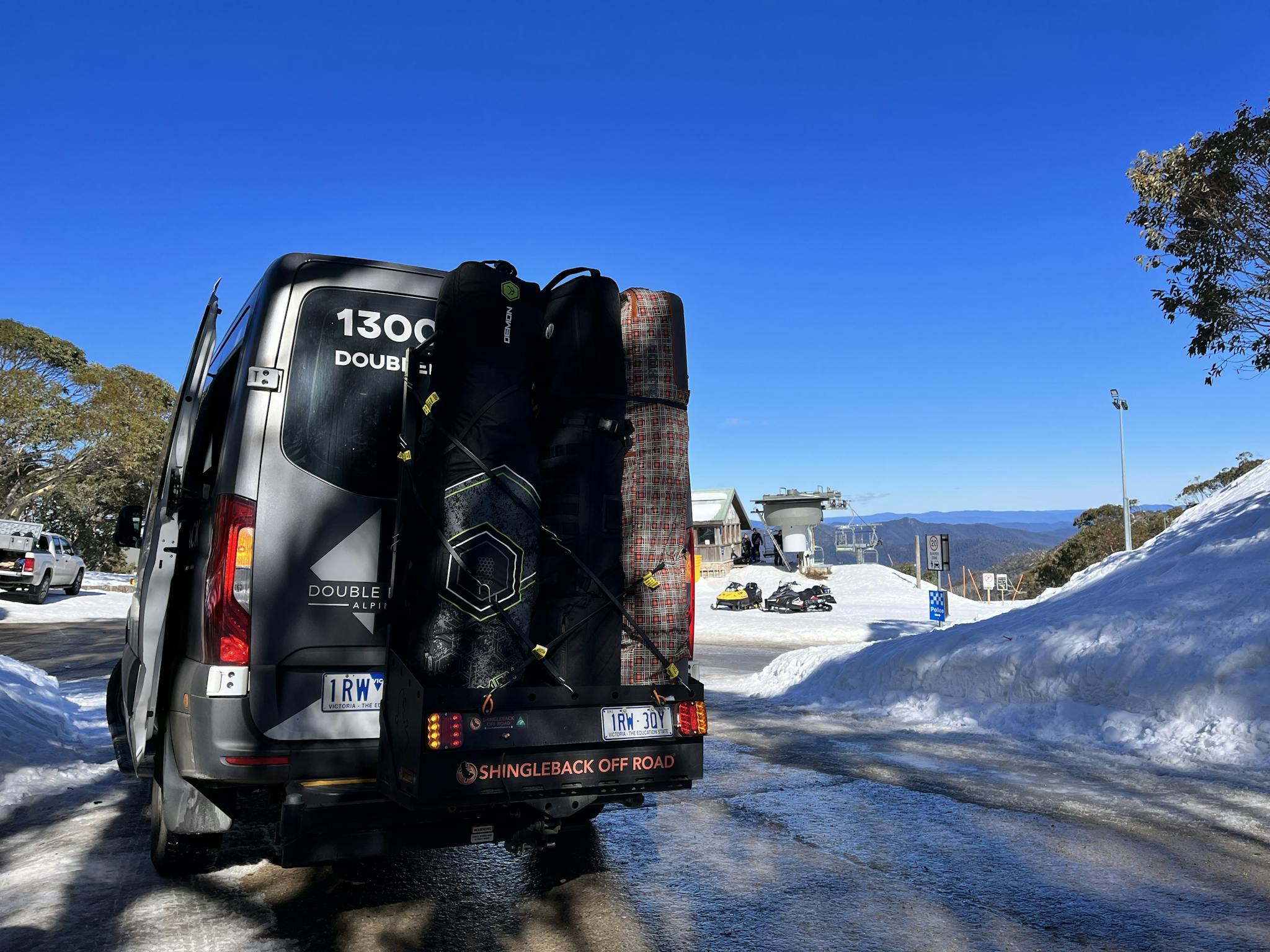 Skis loaded into Double Black Alpine carrier, set for snow, sunshine, and adventure on Mount Buller.