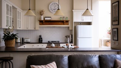Lounge room looking into a kitchen