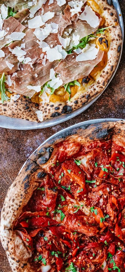 Four types of pizza laid out on a table