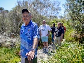 Fred Carriage takes a tour group for a walk along the Coomee Nulunga Cultural Track Fred Carriage takes a tour group for a walk along the Coomee Nulunga Cultural Track