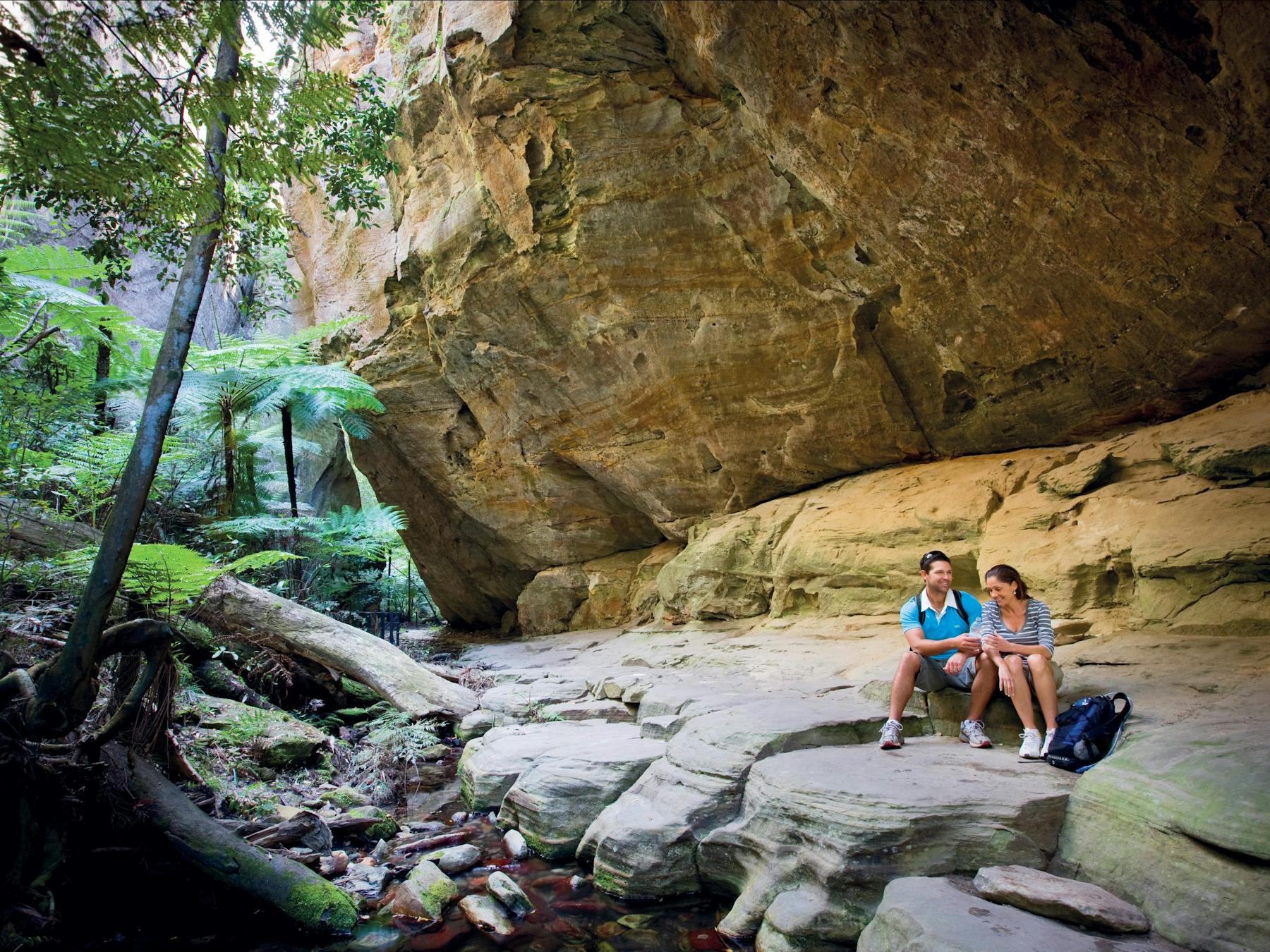 Couple sitting on rocky outcrop in Wards Canyon.