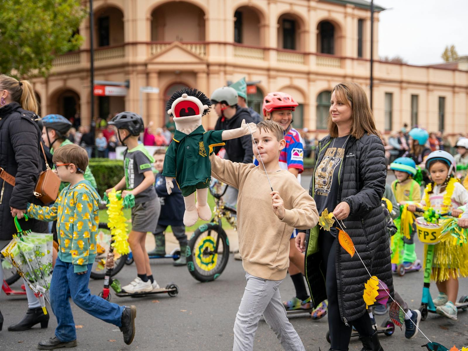 l a street parade, surrounded by other children.