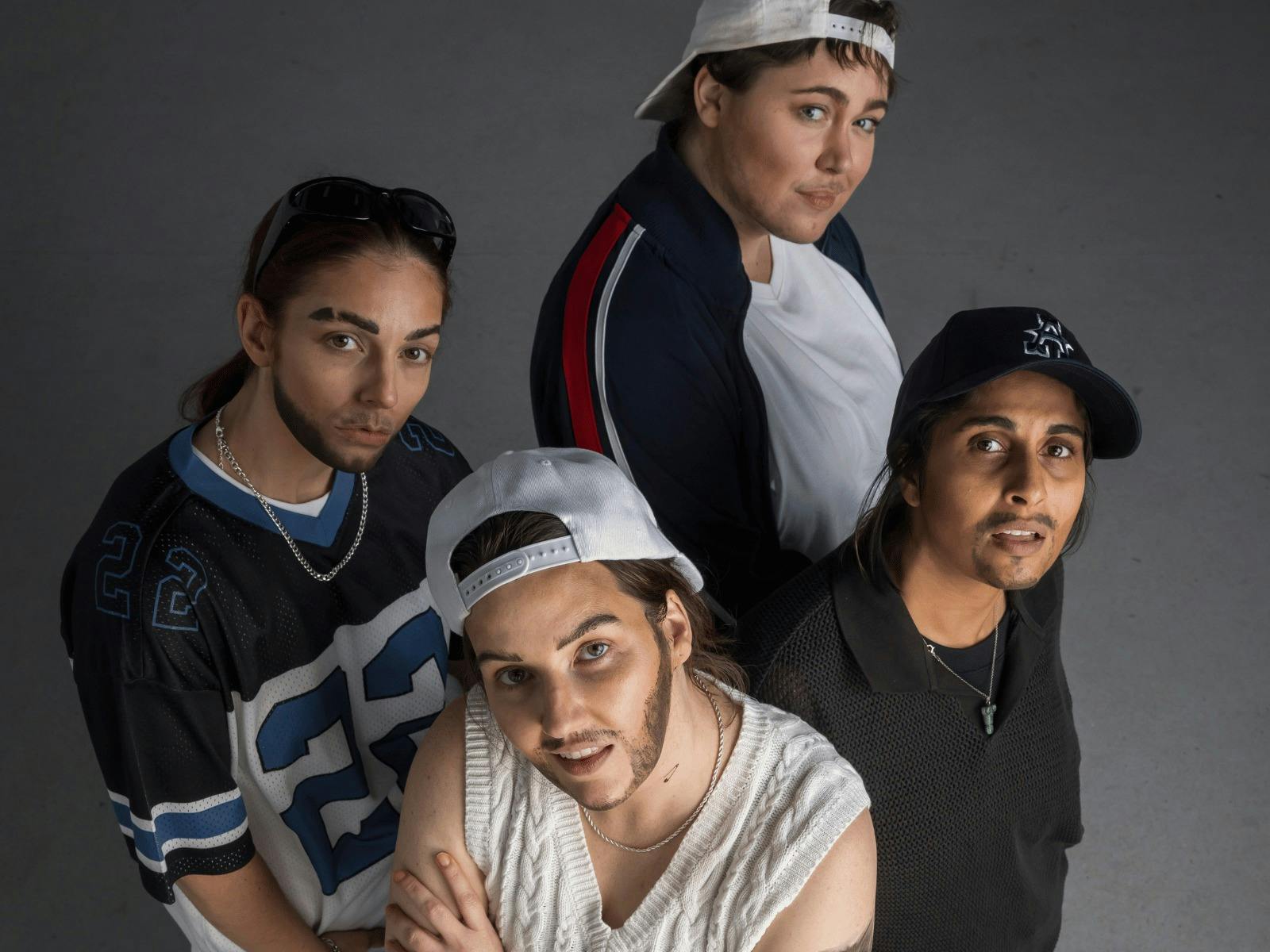 Four Drag Kings dressed as boy band members