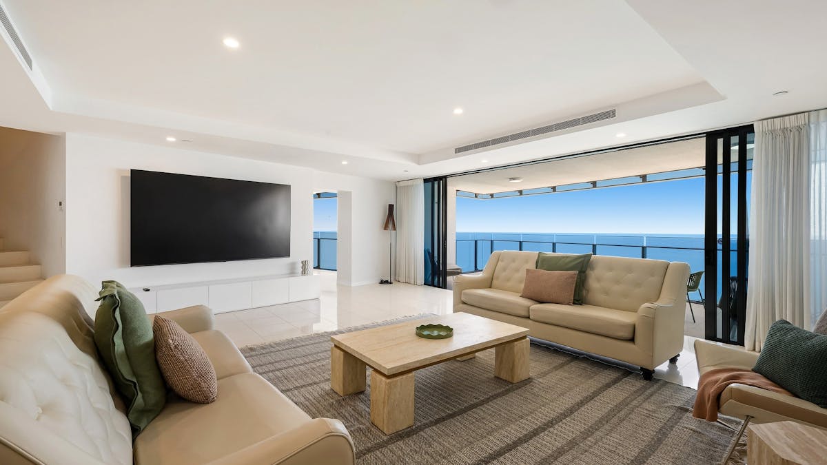 Main living room with ocean views, huge smart tv and balcony - Gold Coast Holidays Soul Peppers