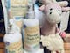 Daisy Cow baby range in pump bottles, packet and cow shaped natural soap with a pink cow toy