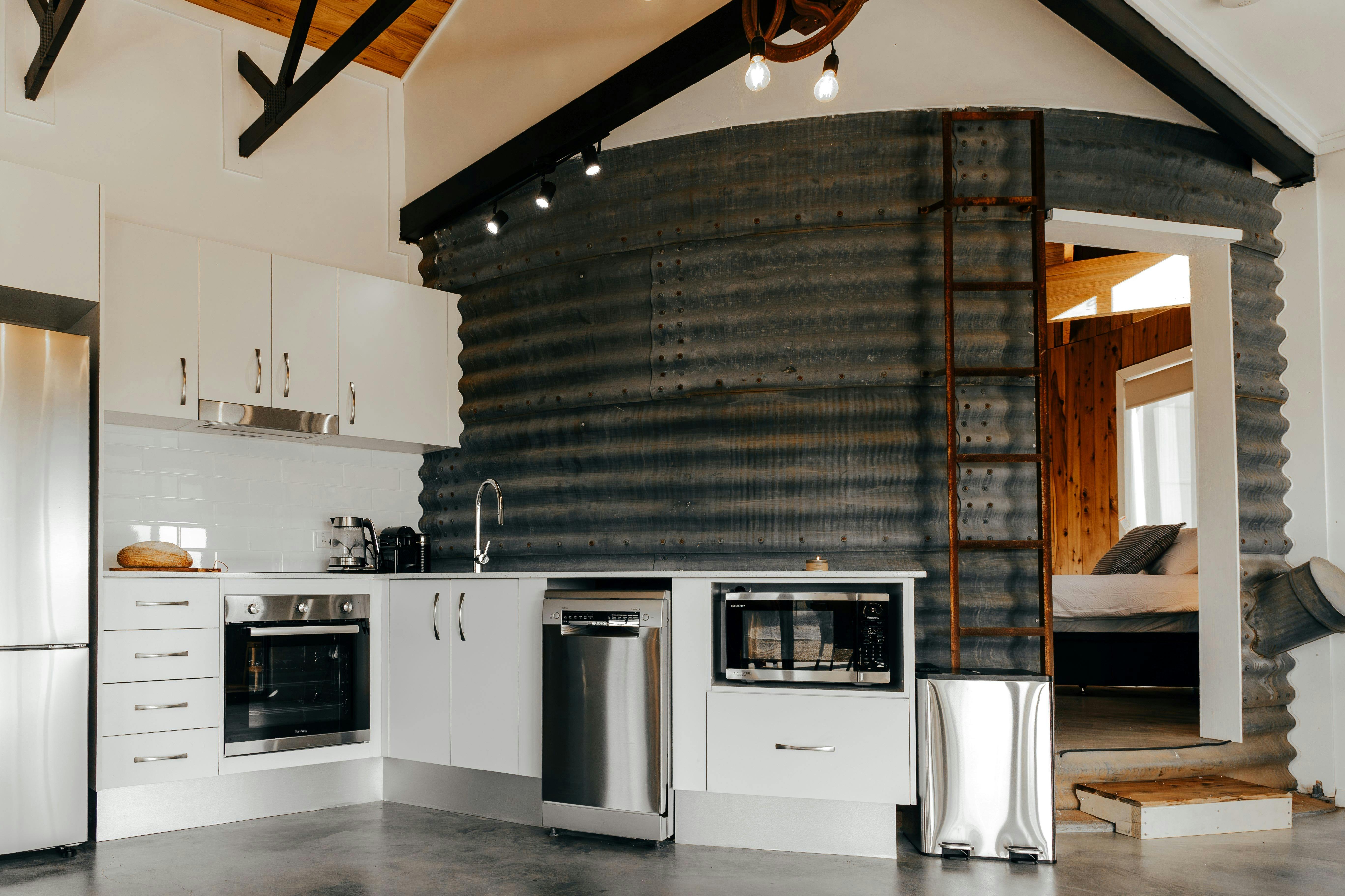 Original silo wall is a feature of the modern well-equipped kitchen