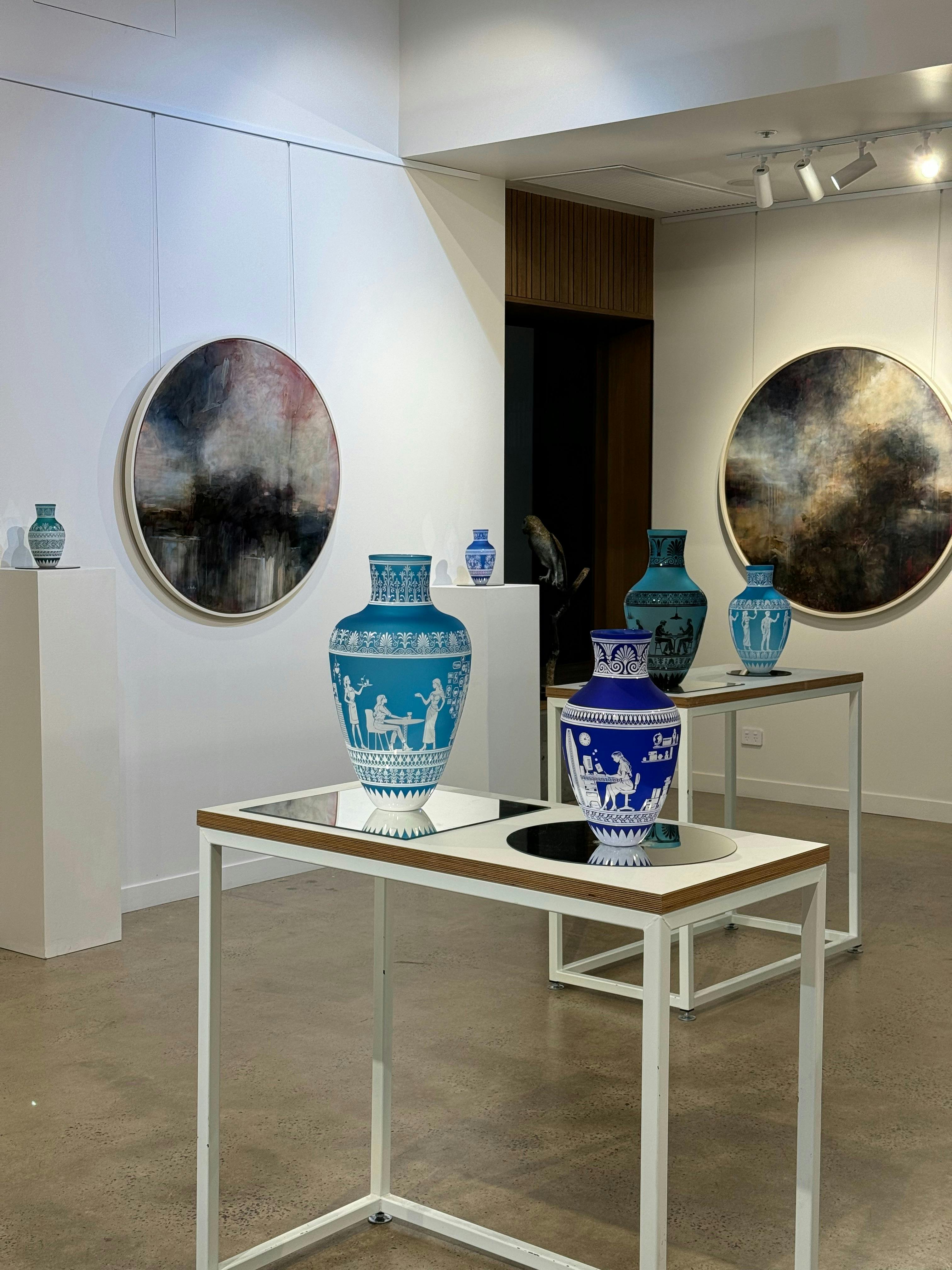 Glass amphoras and lancscape paintings