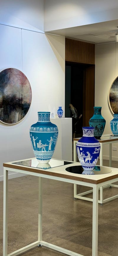 Glass amphoras and lancscape paintings