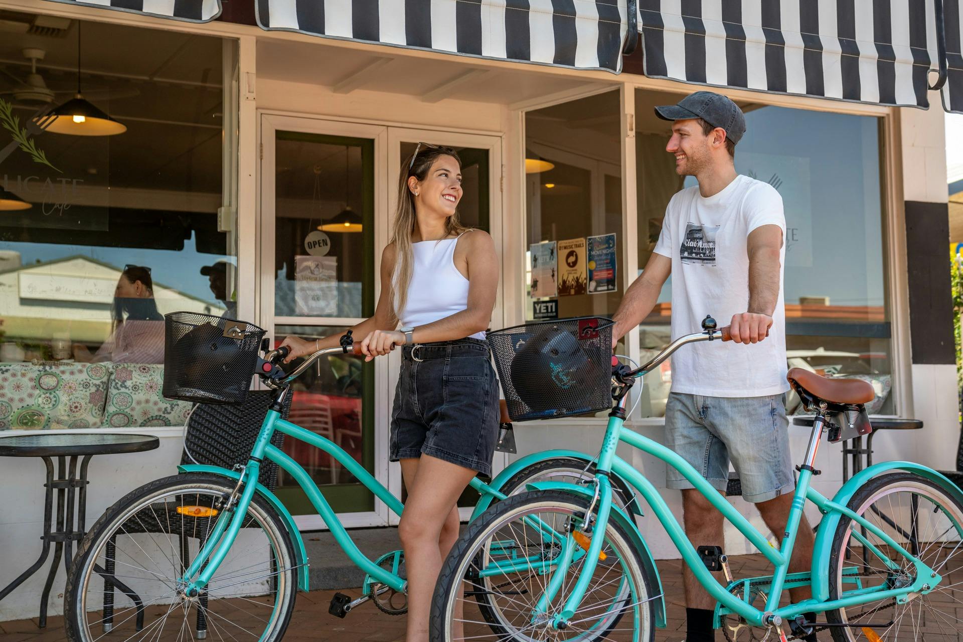 bikes being ridden in front of cafe