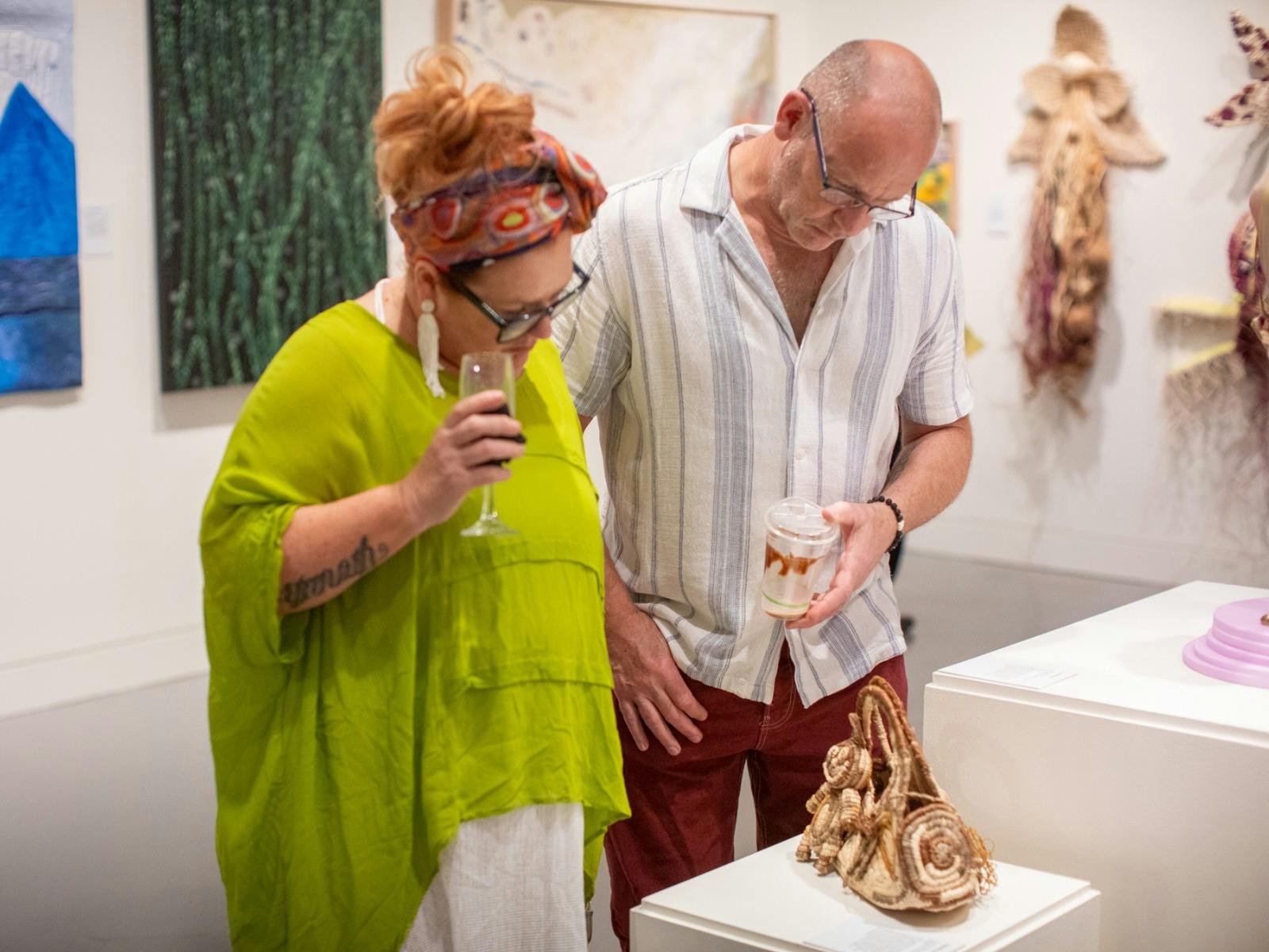 People looking at artwork in an exhibition at the Museum of Art and Culture Lake Macquarie