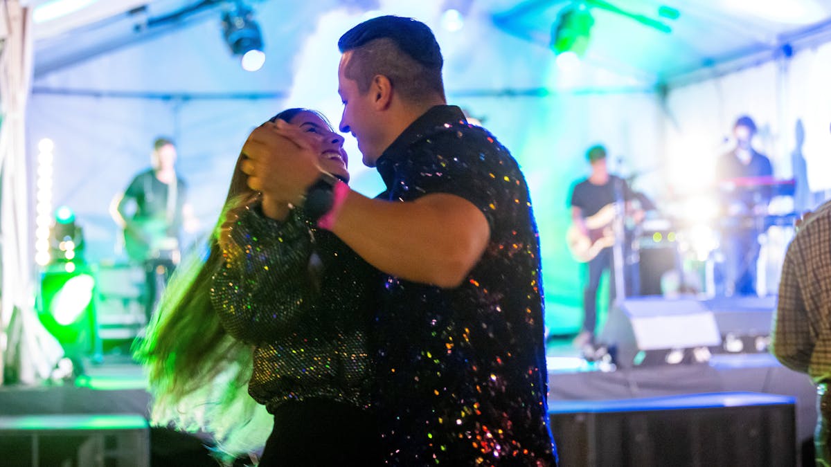 Couple dancing hand in hand to live music Couple dancing hand in hand to live music