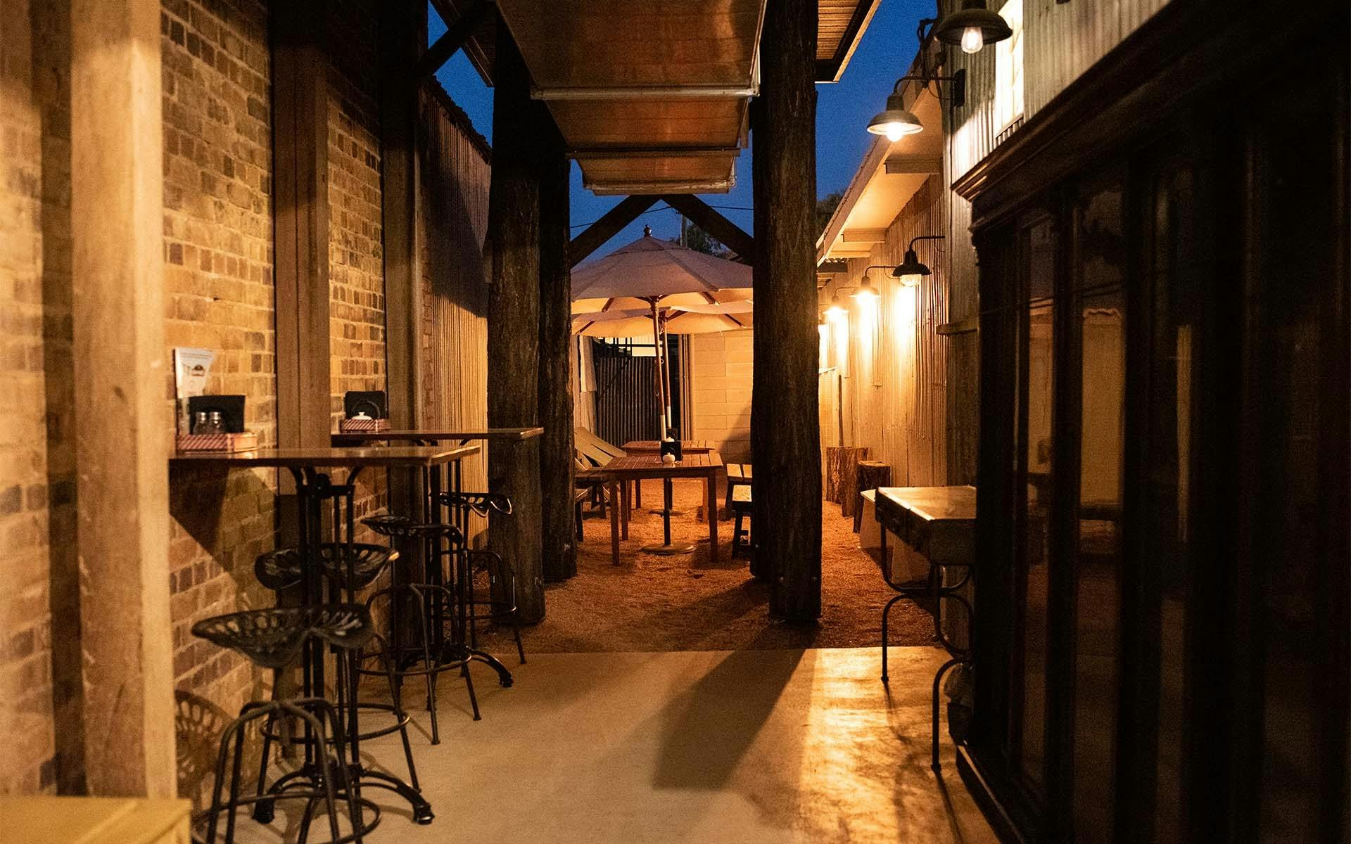A well lit hallway with tables and chairs