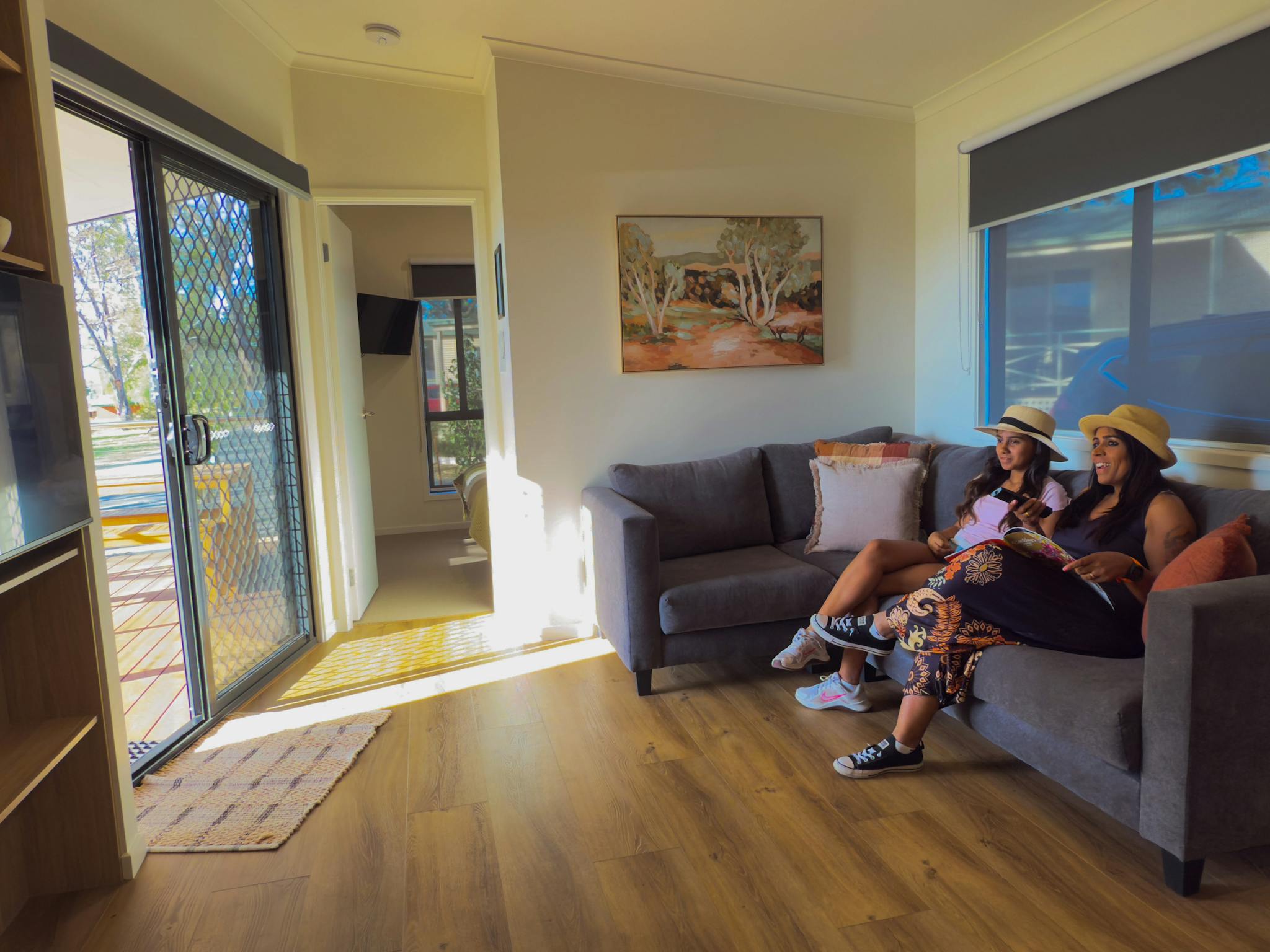 Visitors sitting on a couch in the new deluxe cabin