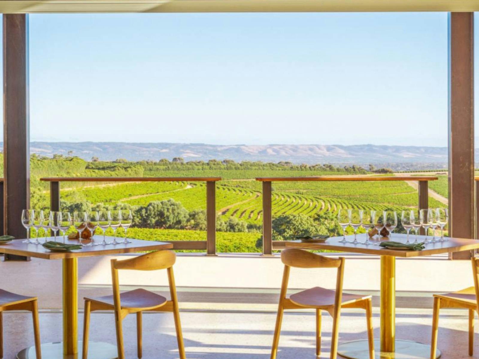 Looking out from the Wonder Room over hills of vines with interior furniture in the foreground