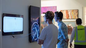 Two men watching a video artwork