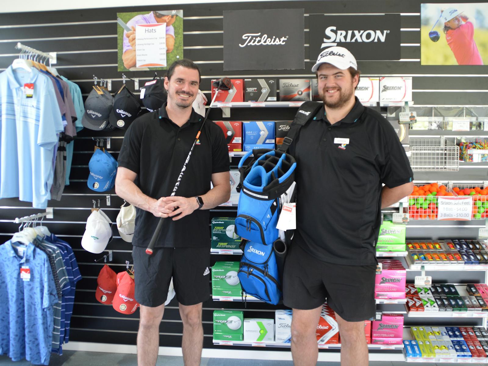 Two men stading in front of the golf retail display