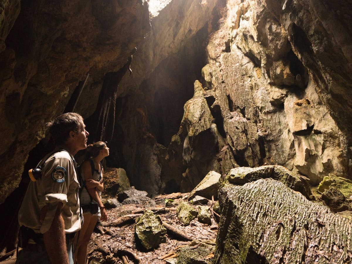A park ranger and woman tour through Royal Arch Cave in Chillagoe, Tropical North QLD.