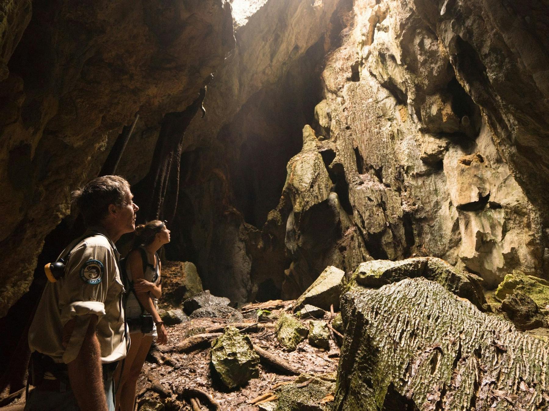 A park ranger and woman tour through Royal Arch Cave in Chillagoe, Tropical North QLD.