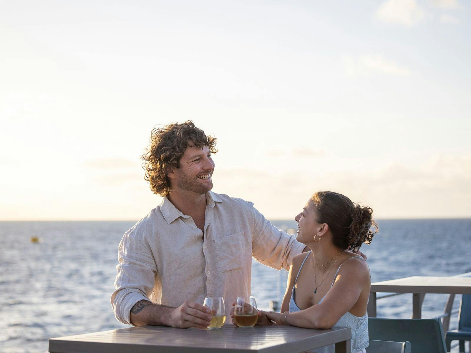 A couple enjoying the sunset canapes