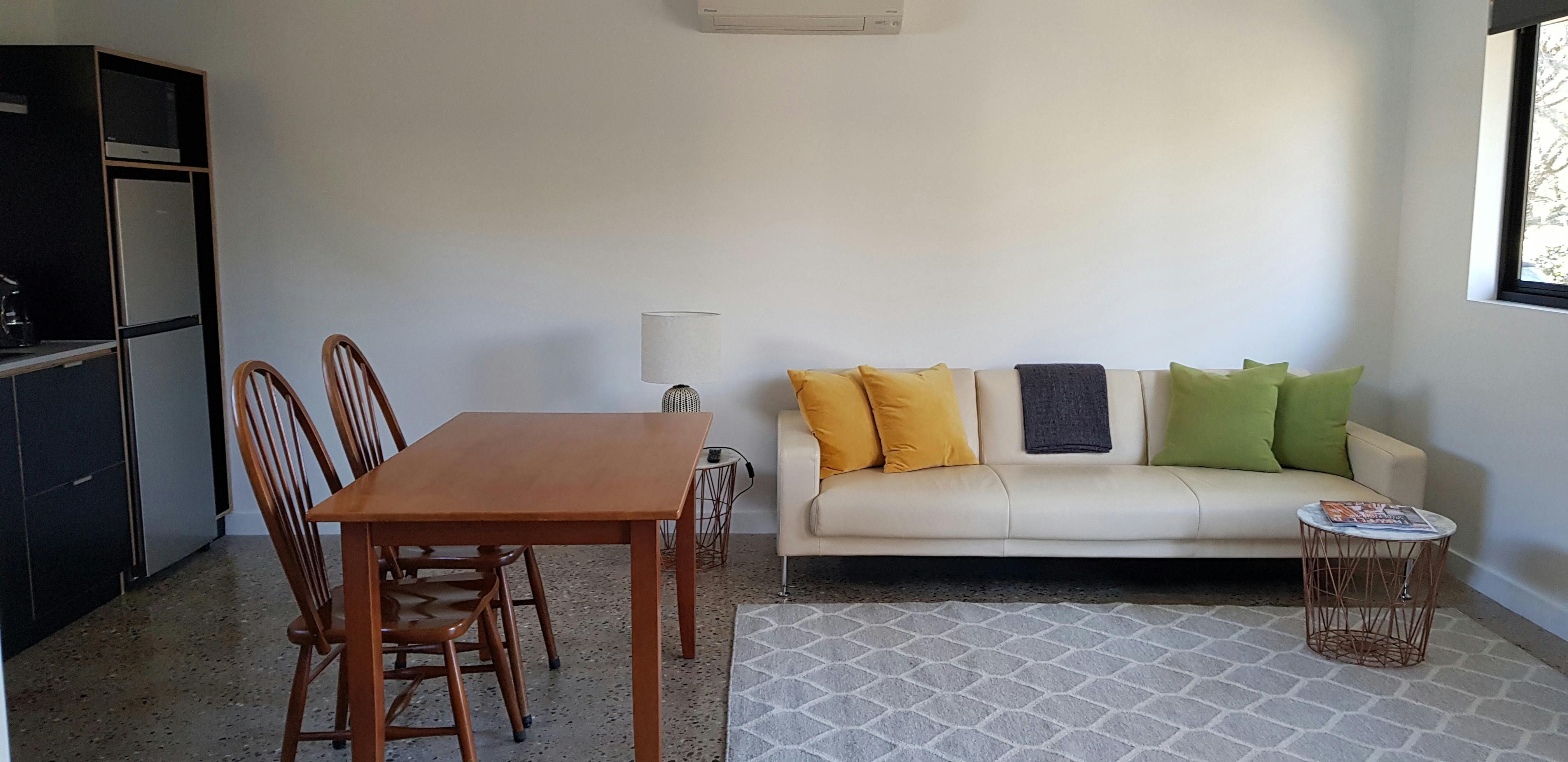 Comfortable lounge suite, garden views, smart TV, polished concrete floors.