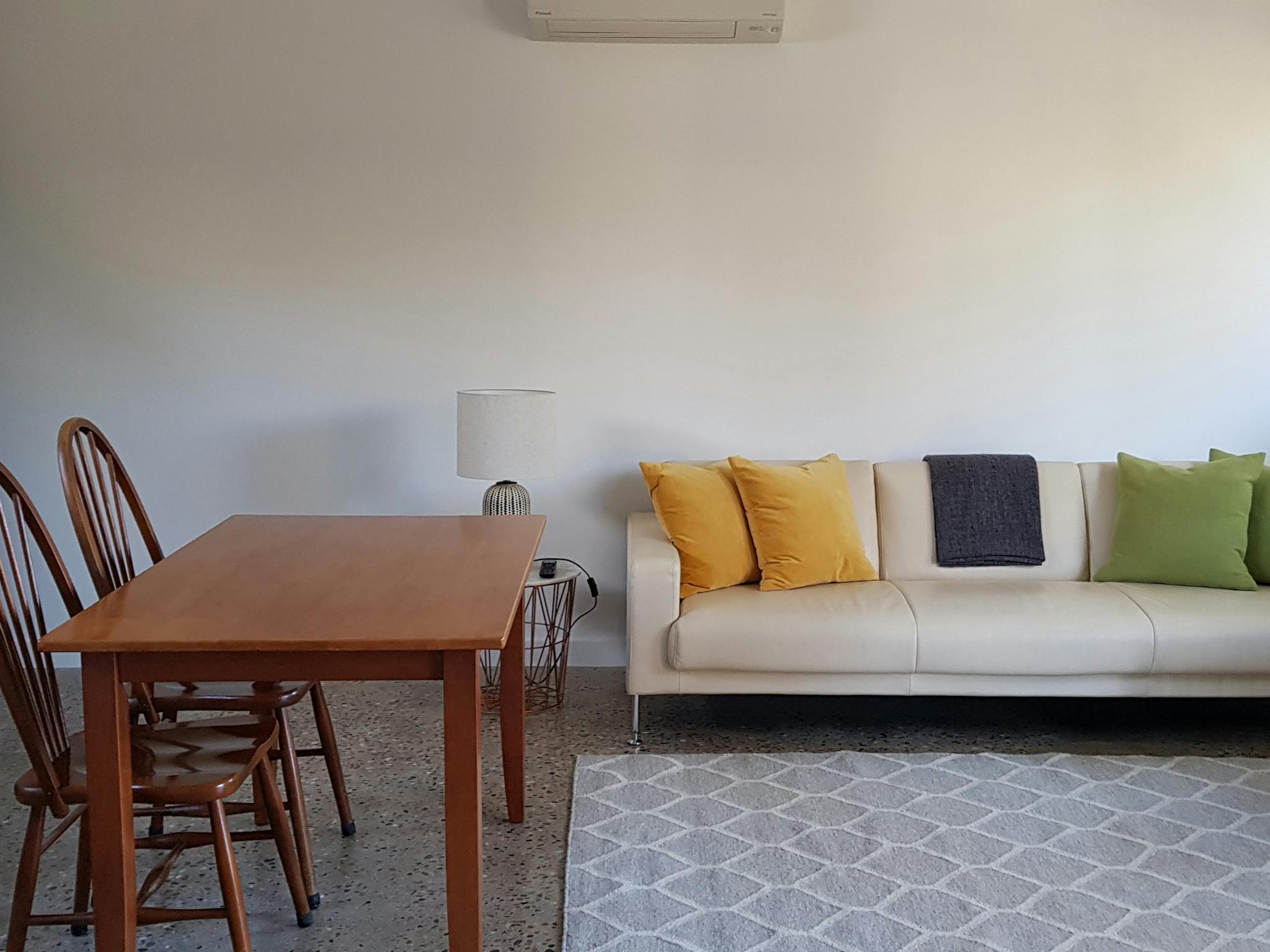 Comfortable lounge suite, garden views, smart TV, polished concrete floors.