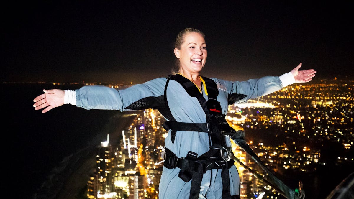 Climber doing the lean back at night