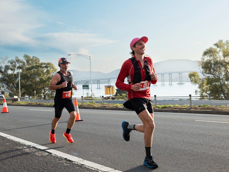 Runners running along Hobart Road with Tasman bridge in the background