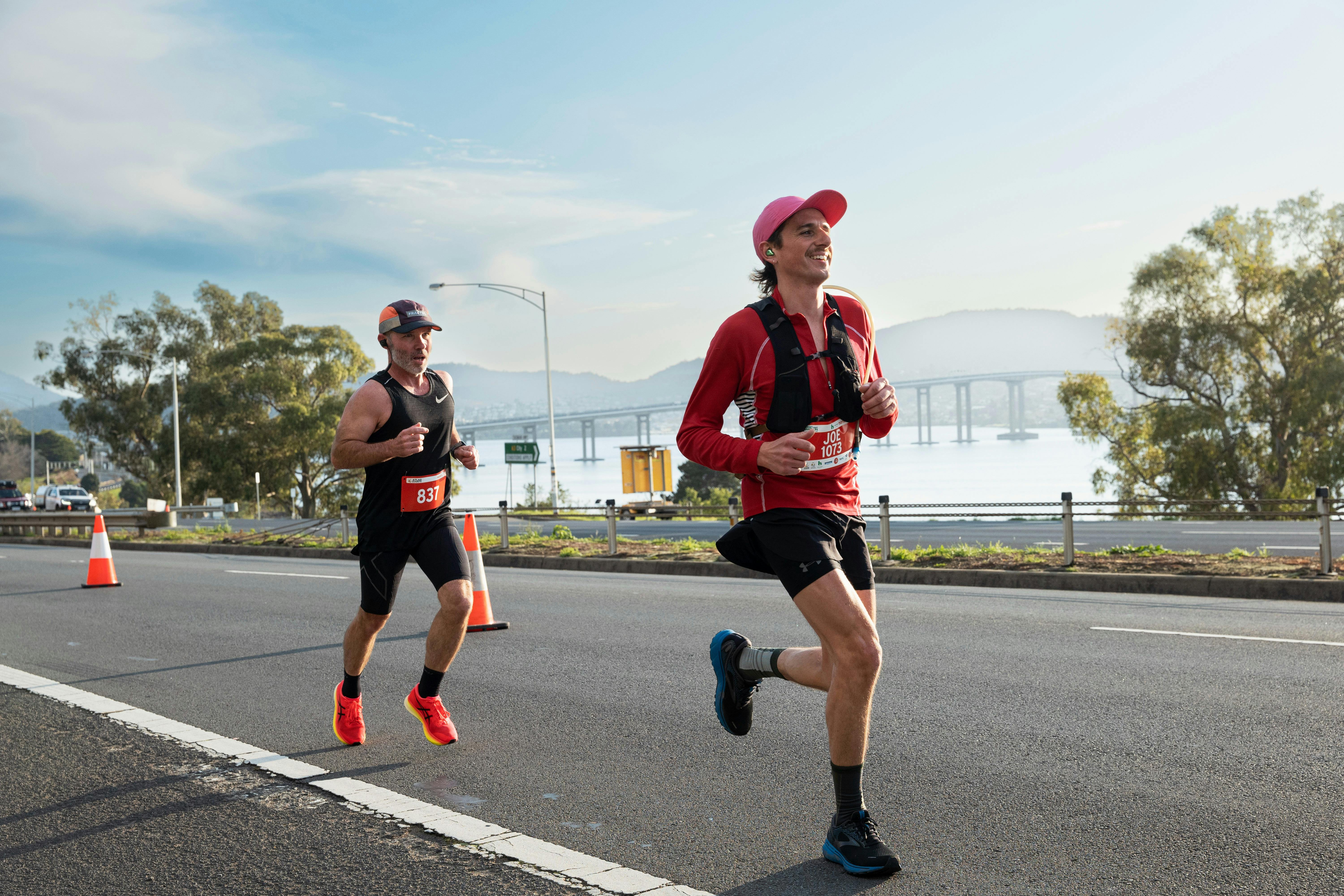 Runners running along Hobart Road with Tasman bridge in the background