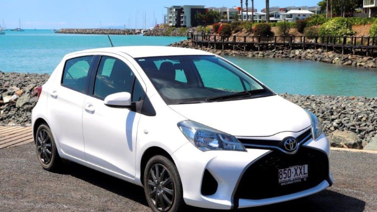 Small 5-seater car for hire with beach backdrop