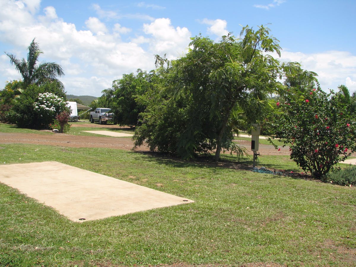 Drive-through sites with slab, water, power and sullage and pretty gardens