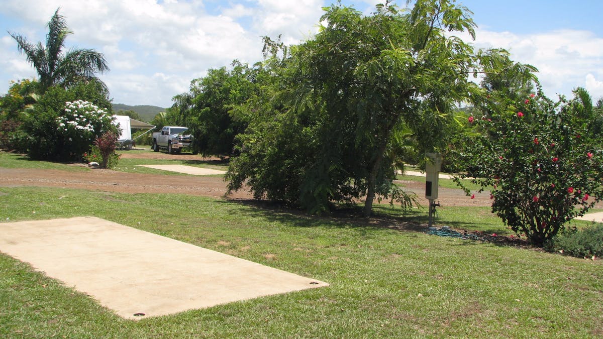 Drive-through sites with slab, water, power and sullage and pretty gardens