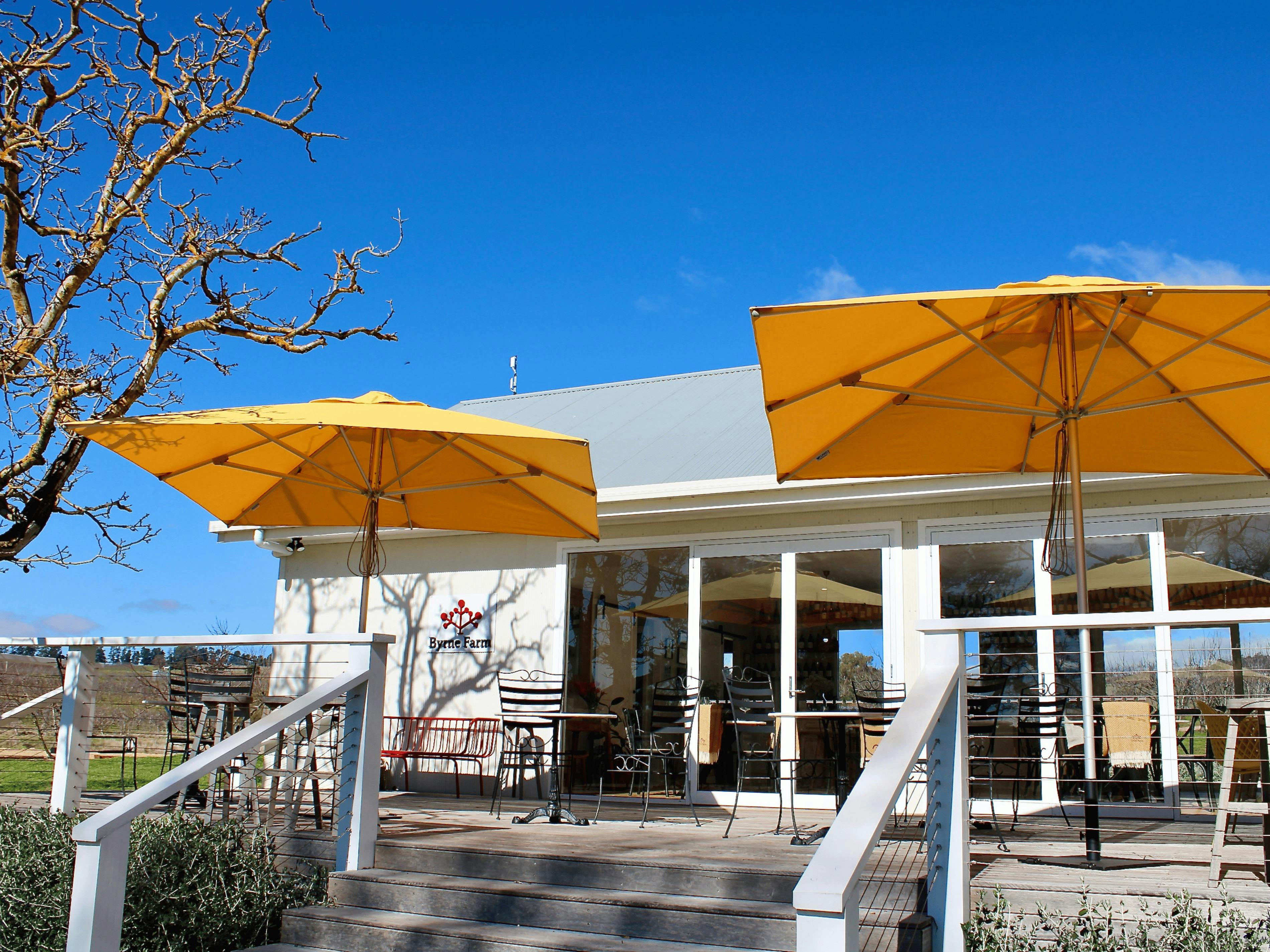 Byrne Farm cellar door and balcony with yellow umbrellas