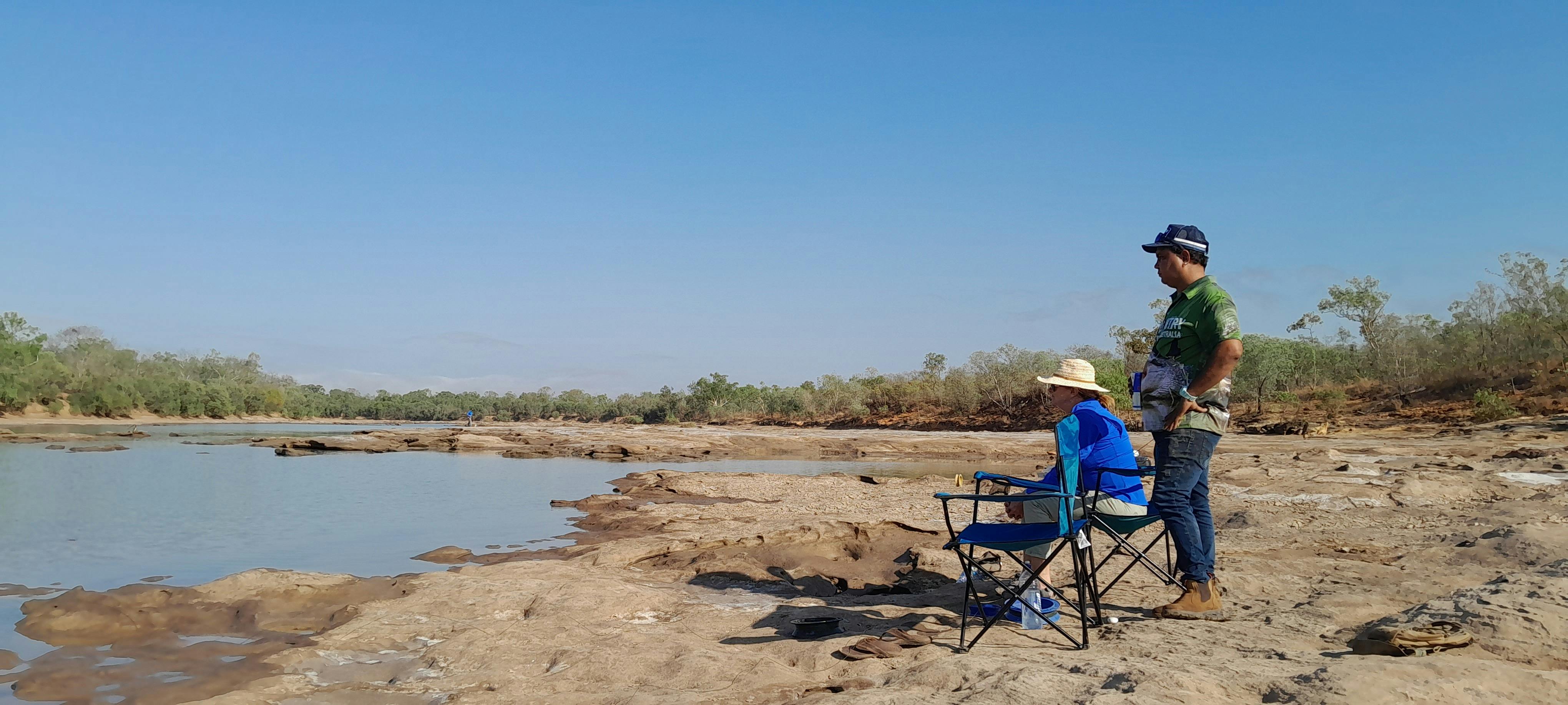 Peter and his guest waiting by a Kimberley river fishing, and waiting patiently for a bite.
