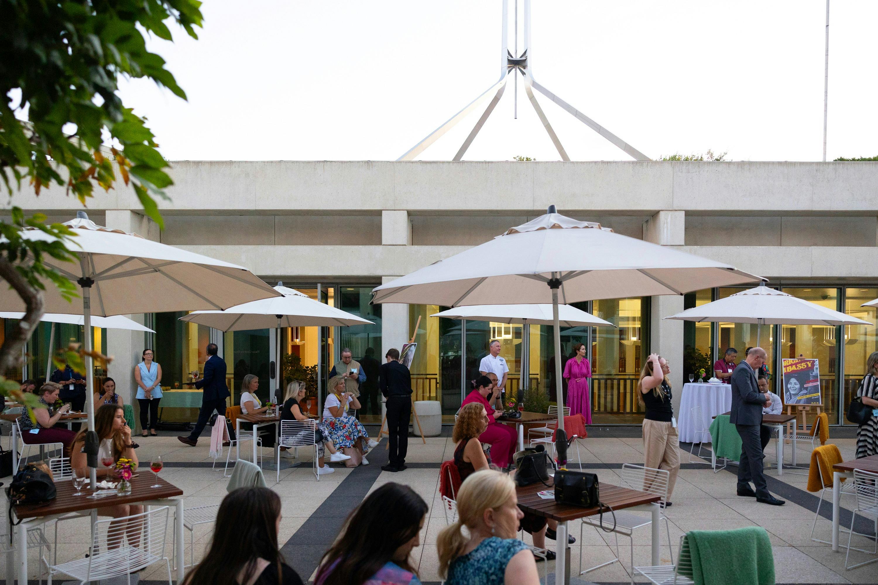 The Queen's Terrace at dusk filled with people.
