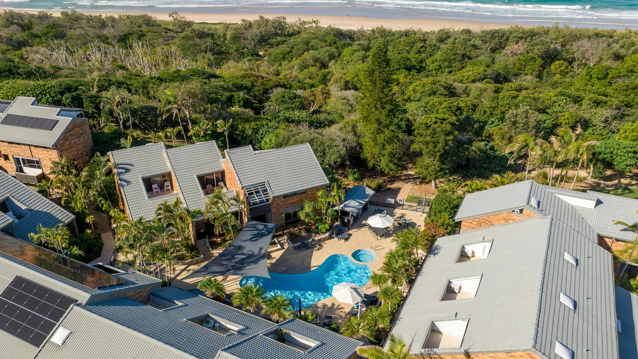 Aerial view of Glen Eden Beach Resort showcasing the resort facilities and proximity to the beach Aerial view of Glen Eden Beach Resort showcasing the resort facilities and proximity to the beach