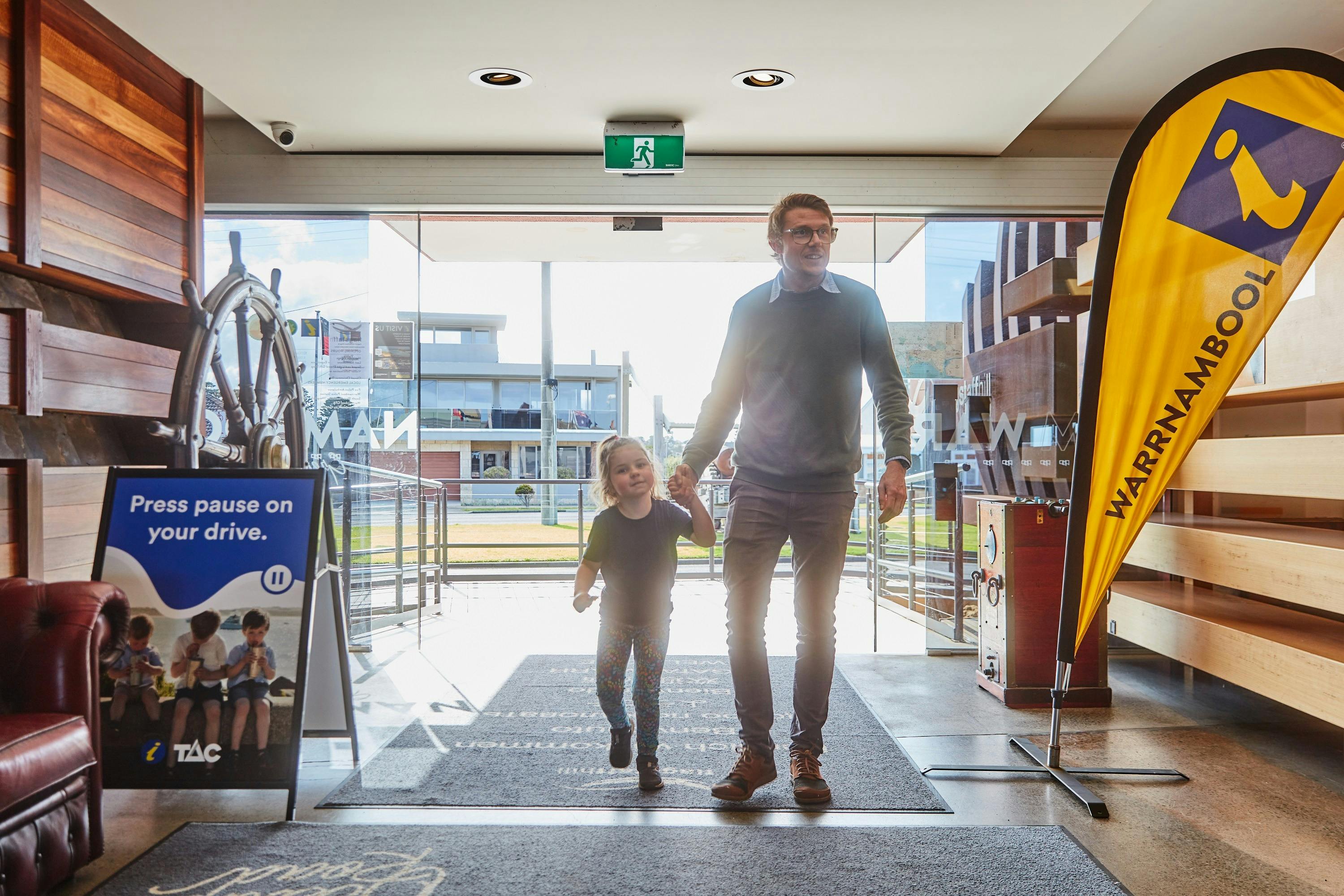 man and child entering the visitor information centre