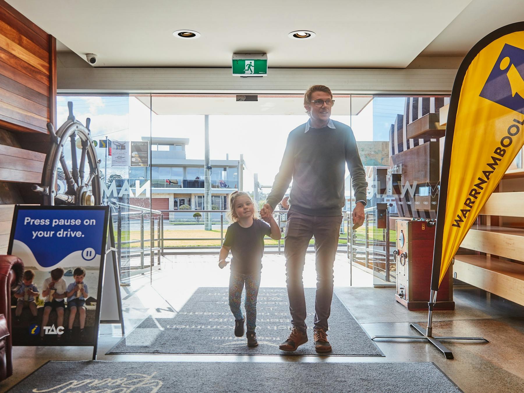 man and child entering the visitor information centre