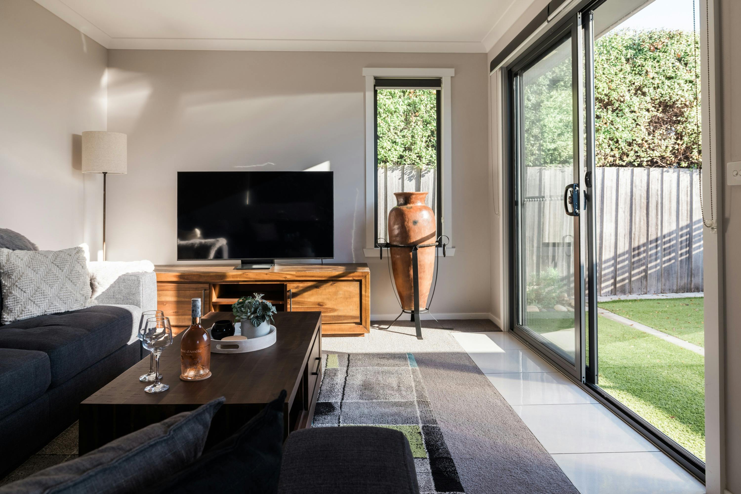 Relax in the stylish living area featuring two brand-new 2-seater lounges and a 55-inch Smart TV.