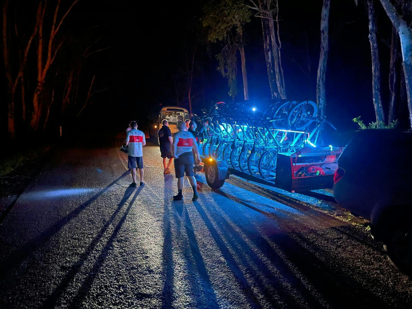 Riders putting bikes back on trailer after night ride in Kakadu