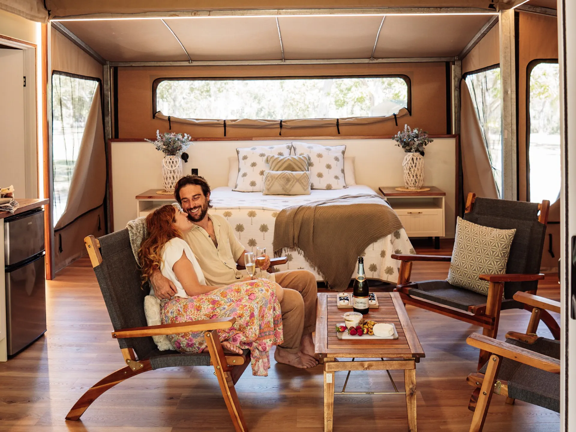 Couple sitting together in a glamping tent