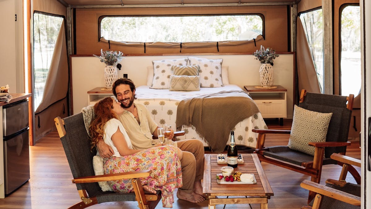 Couple sitting together in a glamping tent