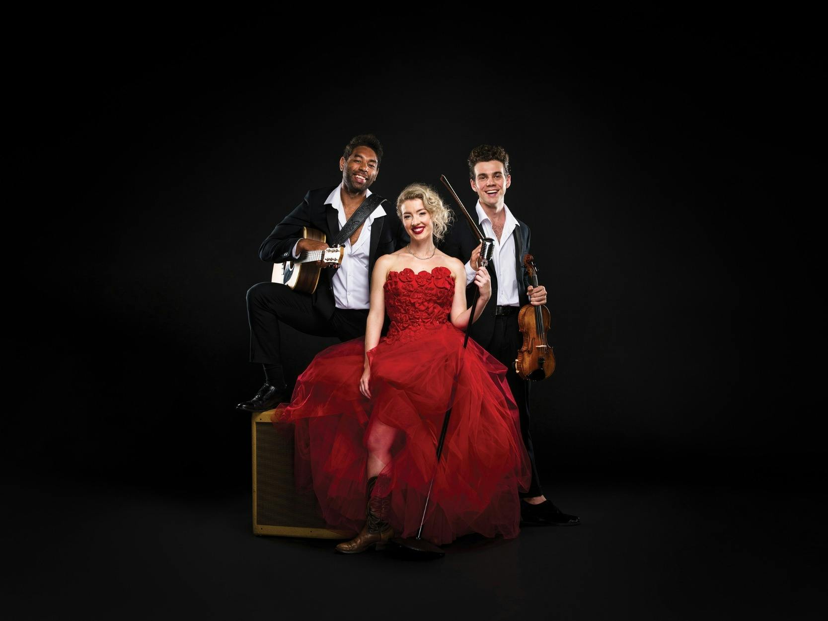 Lady in red dress with two musicians