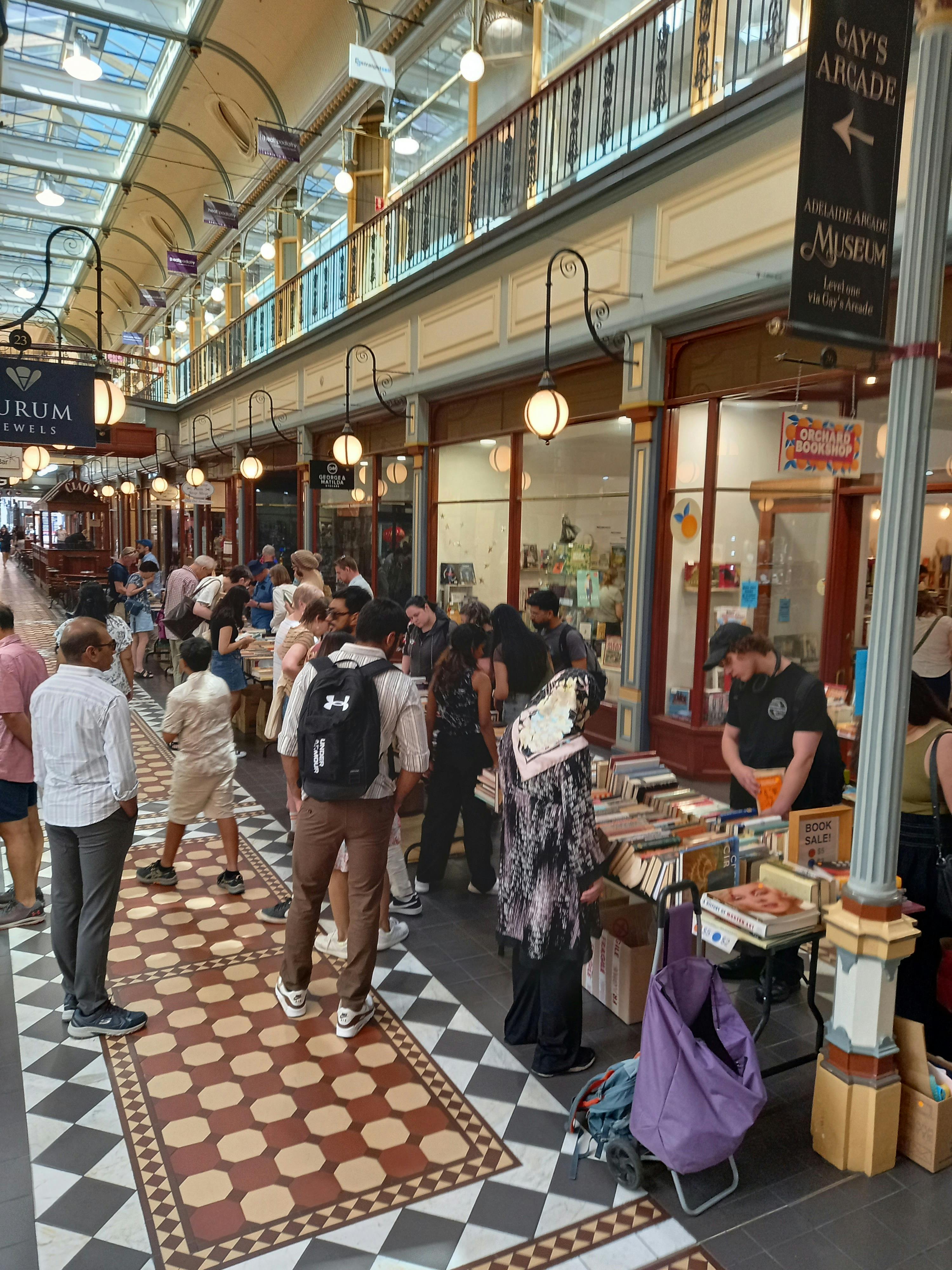 People browsing tables laden with books out front of Orchard Bookshop