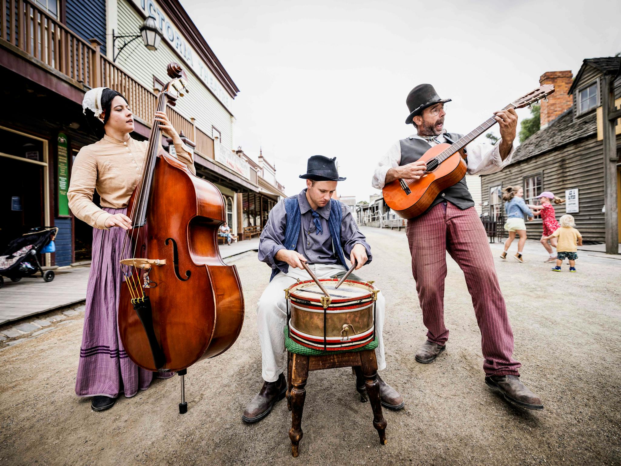 Three costumed performers playing in band in Main Street Sovereign Hill