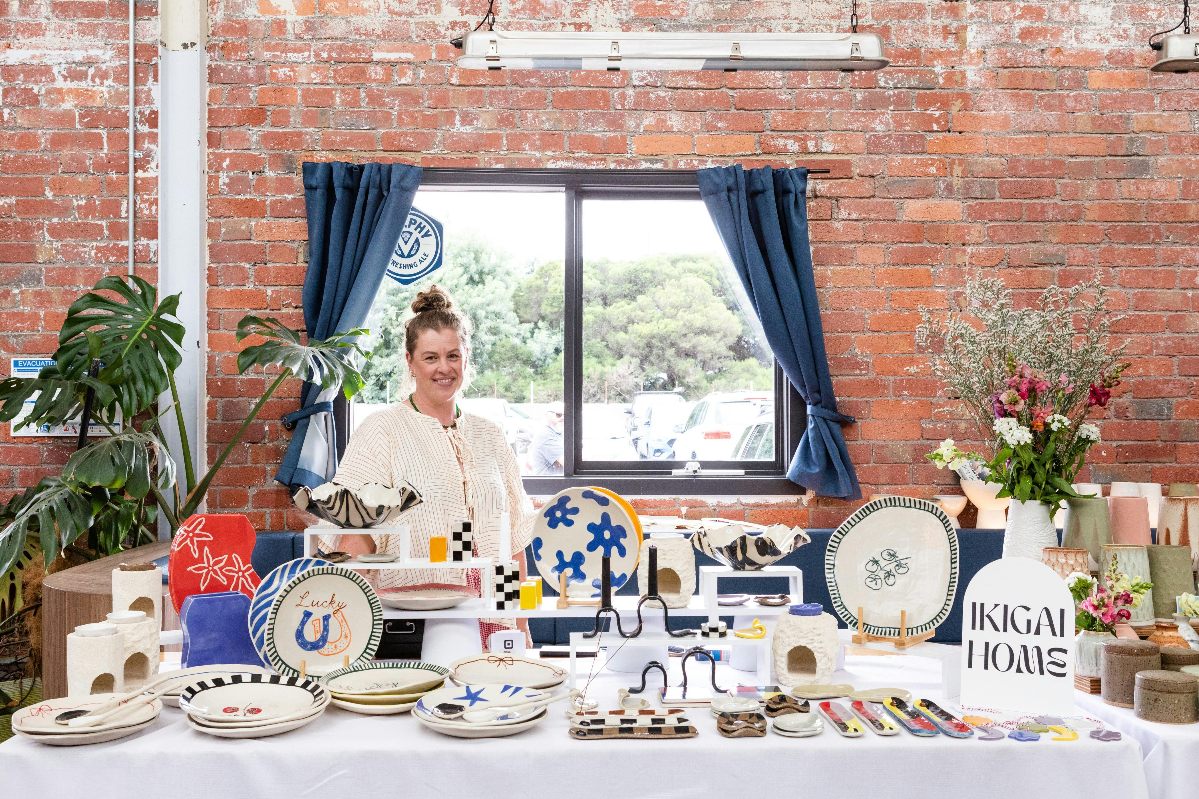 Artist posing with their ceramics